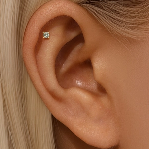 Macro view of a gold-plated s925 silver stud earring with a natural green moss agate stone