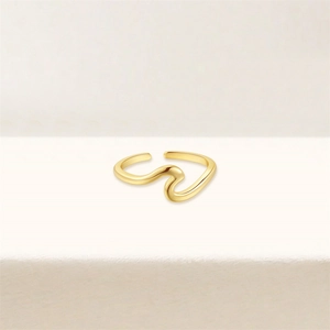 Close-up of a polished golden wave ring with a sleek mirror finish and adjustable opening