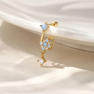 Macro detail of S925 silver sunflower earring with blue opal and sparkling zircon