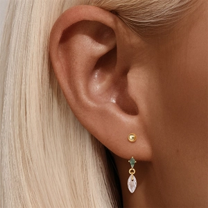 Close-up of s925 silver gold-plated stud earring set with green marquise stones