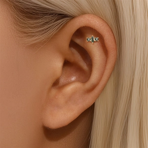Detail of s925 gold-plated ear piercing featuring green moss agate and marquise cut stones