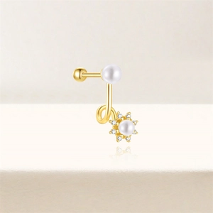 Detail of gold floral cartilage stud with white pearls and sparkling zirconia stones