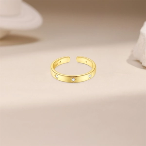 Detail view of gold S925 sterling silver ring showing star motifs and hallmark