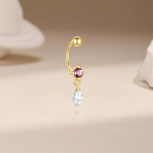 Detail of s925 silver gold piercing with round purple stone and marquise white gemstone