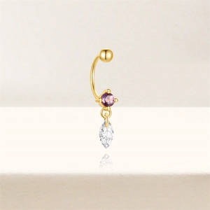 Detailed close-up of gold navel ring with purple round stone and marquise drop charm