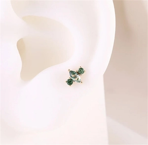 Detail of s925 gold stud earring featuring marquise and round green moss agate on ear model