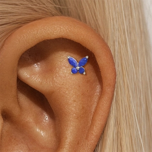 Close-up of a s925 silver butterfly earring with four blue lapis lazuli stones on an ear