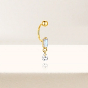Detail of s925 silver curved piercing stud with marquise crystal and gold plating