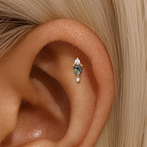 Close-up of s925 gold stud earring with green moss agate and sparkling zircons