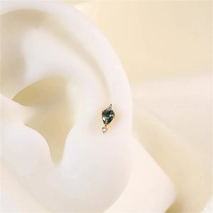 Macro detail of S925 silver moss agate stud earring with small round zircon accents