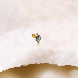 Macro view of teardrop moss agate stud earring with gold plating and cubic zirconia
