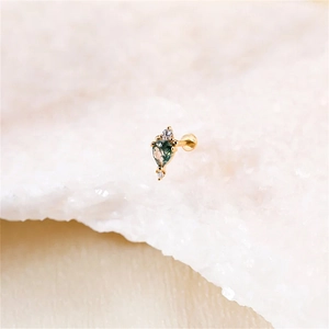Macro shot of s925 gold moss agate stud earring with pear-cut green stone and side diamonds