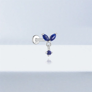 Macro shot of S925 silver stud earring featuring blue stones and a leaf-like design
