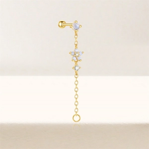 Macro detail of gold S925 silver ear stud with blue opal stone and flower chain