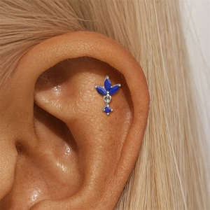 Detailed view of s925 silver ear stud with deep blue lapis lazuli on ear cartilage