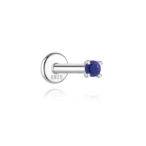Macro detail of S925 sterling silver labret piercing with blue lapis lazuli stone
