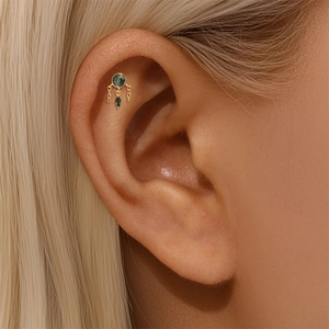 Macro shot of s925 gold earring with natural green moss agate and elegant drop chain