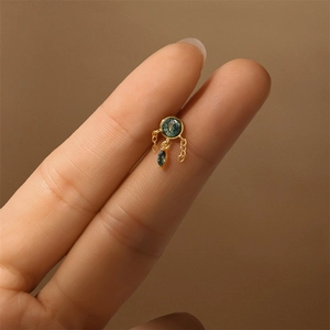 Macro view of gold S925 green moss agate ear stud with chain and marquise stone