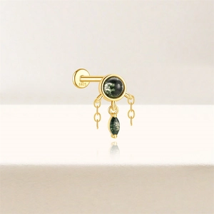 Macro shot of S925 sterling silver ear stud with moss agate stone and gold chains