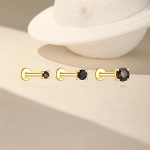 Macro shot of three S925 sterling silver black gemstone labret studs in gold finish