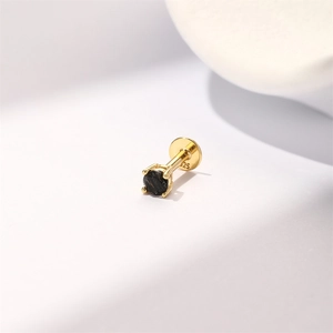 Macro detail of gold S925 sterling silver ear stud with black round gemstone setting