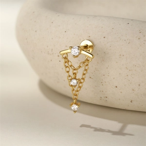 Macro shot of 925 silver gold-plated tassel earring with sparkling cubic zirconia stones