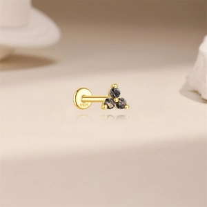 Macro view of gold S925 sterling silver earring with black gemstone inlay