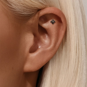 Detailed view of s925 silver black crystal flower piercing stud on ear cartilage