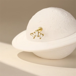 Detail view of S925 sterling silver stamp on golden ear stud with zircon stones
