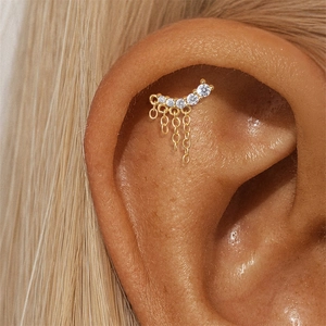 Detailed view of s925 silver gold ear stud with curved zircon gems and hanging tassels