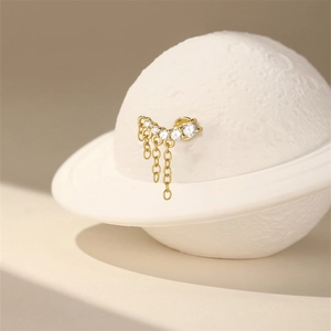 Detailed view of s925 silver golden cartilage stud with crown tassel and zircons