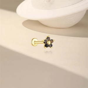 Close-up of S925 sterling silver flower stud with black crystals and gold-plated finish