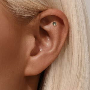 Detailed close-up of s925 silver ear stud with black rutilated quartz and gold plating