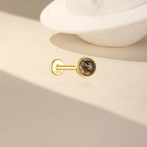 Macro detail of S925 silver ear stud featuring rutilated quartz and flat screw back