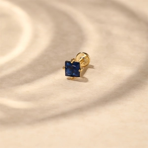 Macro view of S925 sterling silver ear stud with square blue zircon in four-prong setting