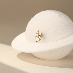 Macro shot of S925 sterling silver crown earring with pear-cut zircon and gold plating