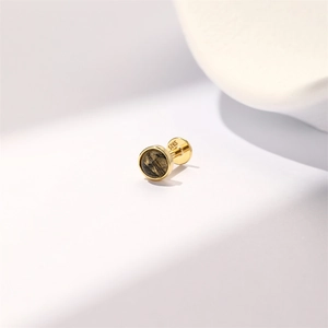 Detailed macro view of gold S925 silver stud earring with black rutilated quartz stone