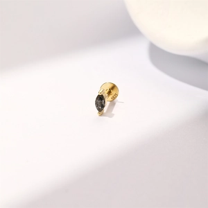 Detailed macro view showing the S925 sterling silver hallmark on gold-toned stud earring