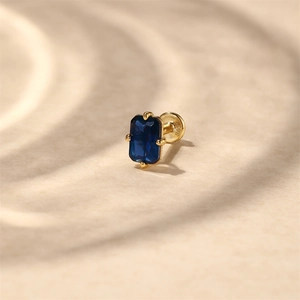 Macro view of S925 silver flat back earring with emerald cut blue zircon in gold