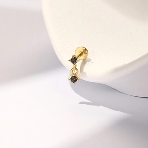 Macro detail of S925 silver gold-plated stud earring with faceted black rutilated quartz
