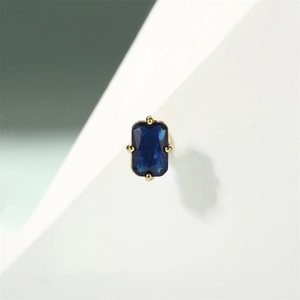 Macro shot of rectangular blue zircon stud with four-prong gold-plated setting
