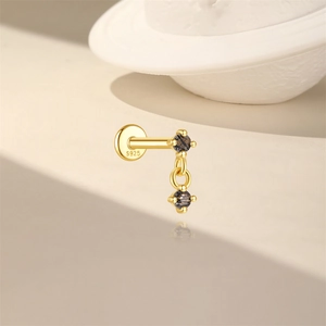 Close-up of S925 silver stamp on gold-plated ear stud with black rutilated quartz