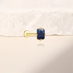 Macro detail of S925 sterling silver stamp on a gold-plated stud with blue zircon