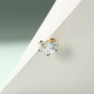 Detail of 16G gold cartilage stud with large half-round cubic zirconia in a 4-prong setting