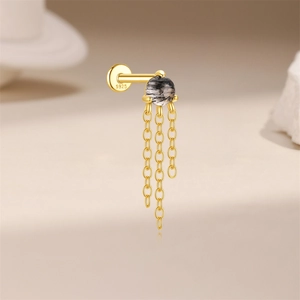 Detail of S925 silver gold-plated labret stud with black rutilated quartz and triple chains