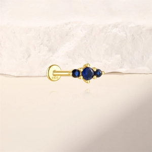 Macro shot of S925 sterling silver earring featuring three blue round zircon stones