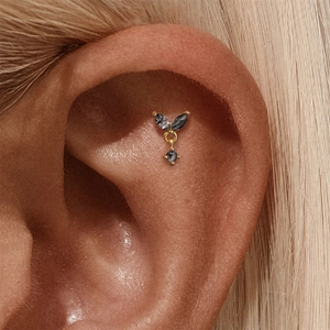 Detailed close-up of s925 silver ear stud with black rutilated quartz on female ear