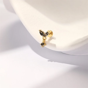 Macro shot showing S925 silver hallmark on a gold leaf earring with black crystals