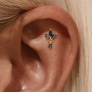 Detail of s925 silver gold ear stud with black rutilated quartz in crown flower design
