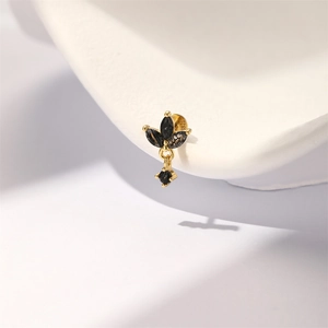 Macro shot of S925 silver gold-plated stud earring with black marquise quartz